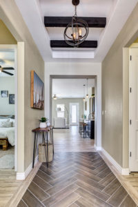 an example of an entrance hallway with patterned tile flooring and unique lighting, showing what quality homes by Cullers Homes look like