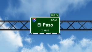 a road sign that says El Paso over the freeway