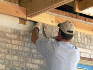 a man from a team of custom homes builders building a home