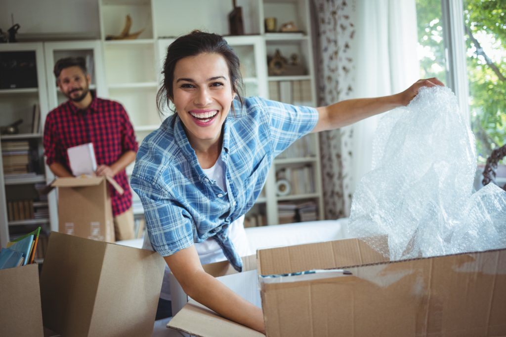 woman and man unpacking in a new house