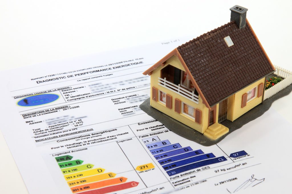 small scale model home on a energy efficiency diagnostic sheet